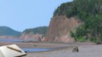 Open travel journal overlooking coastal cliffs in Nova Scotia